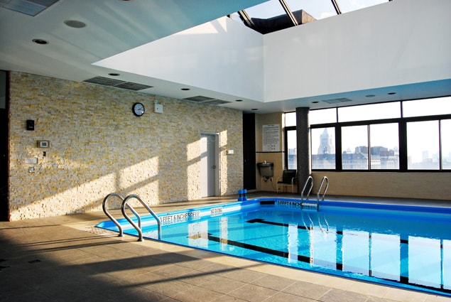 Ivory Ledgestone Feature Wall on Indoor Pool with New York City Skyline Views and a glass roof